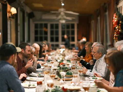 A warmly lit family table prepared for a holiday gathering