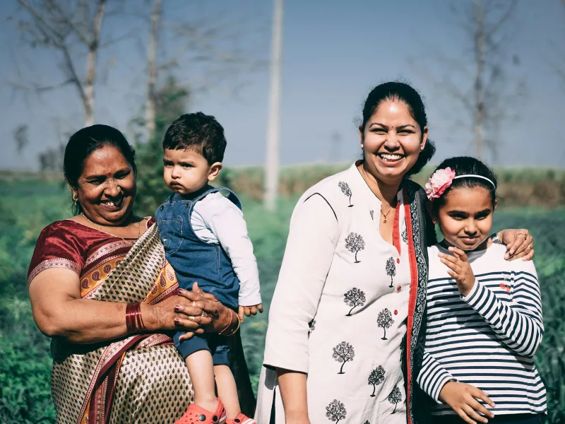 Several generations of a family smiling together outdoors