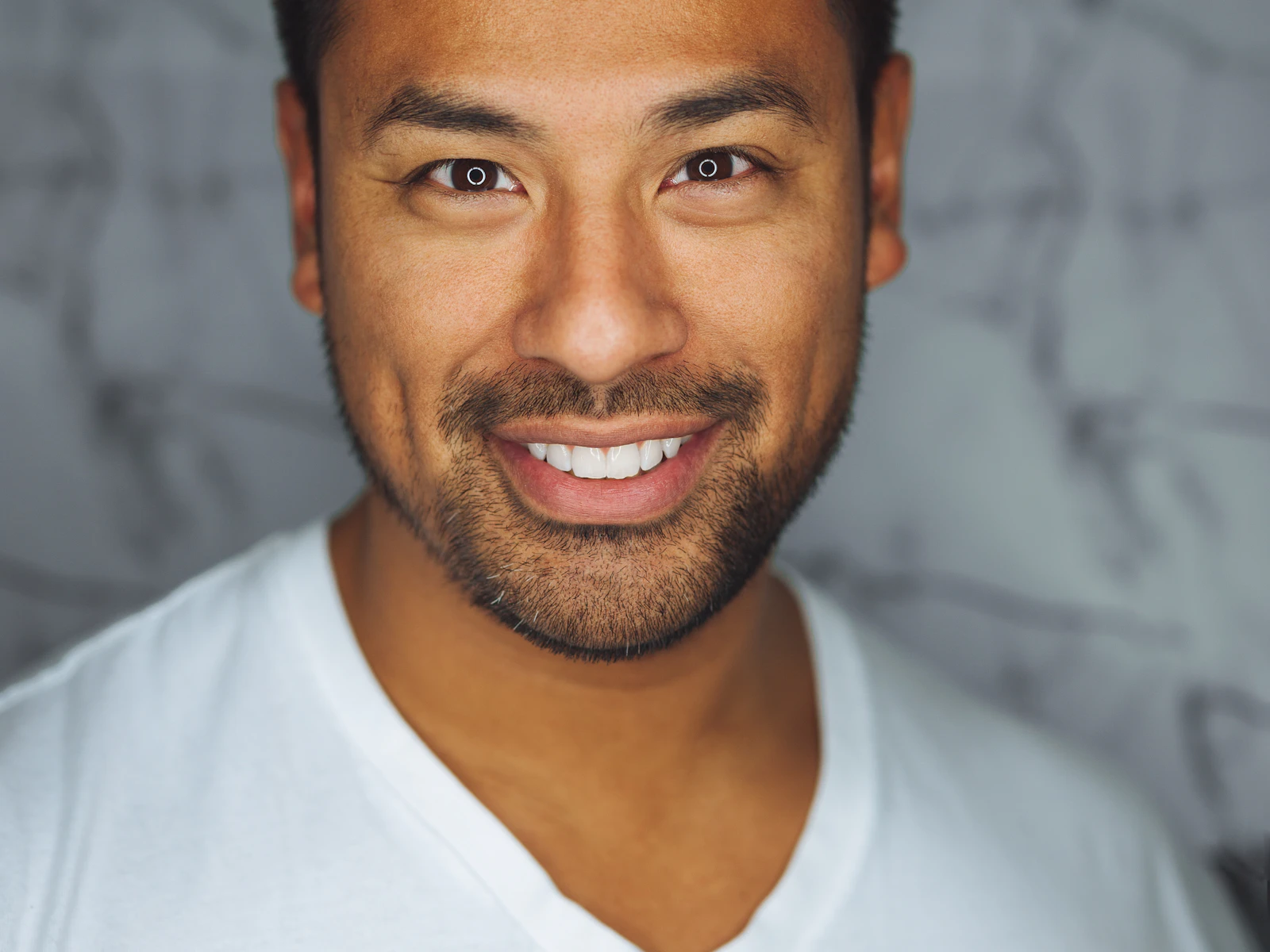 A respected professional smiling in a sunlit office
